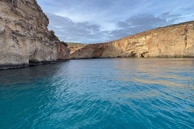 Blue Lagoon Ferry and Caves Tour - Leaving Mgarr Gozo under the blue umbrella
